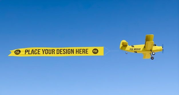 an airplane flying in the air with a yellow sign that says place your design here