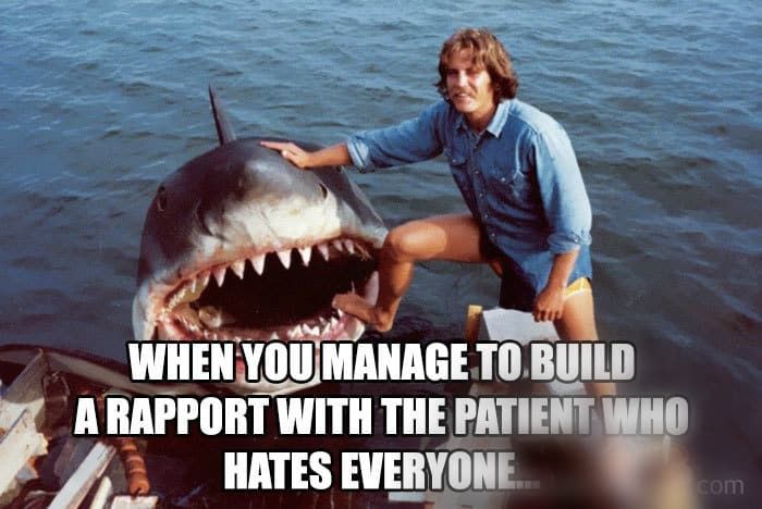 a man on a boat with a shark in the water and caption that reads, when you manage to build a rapport with the patient who hates everyone