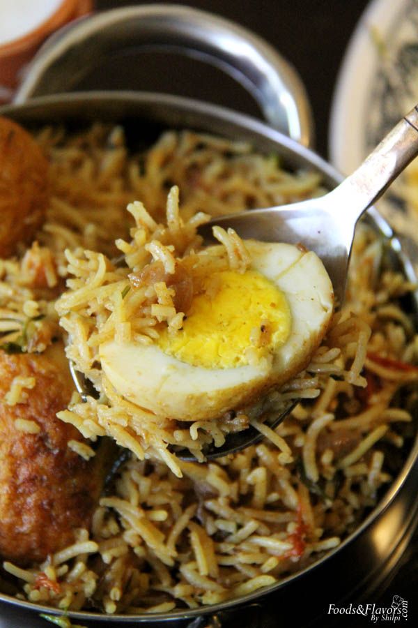 a bowl filled with rice, meat and an egg