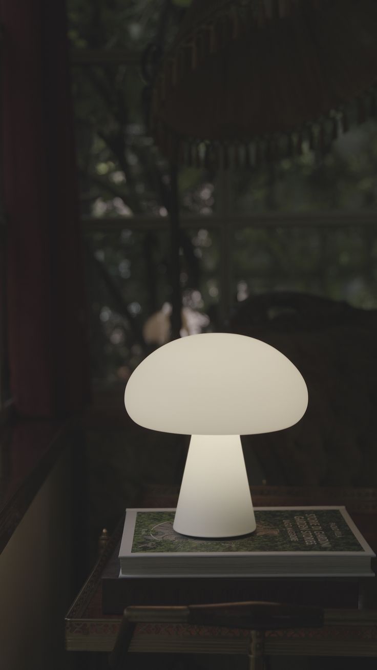 a white mushroom lamp sitting on top of a table