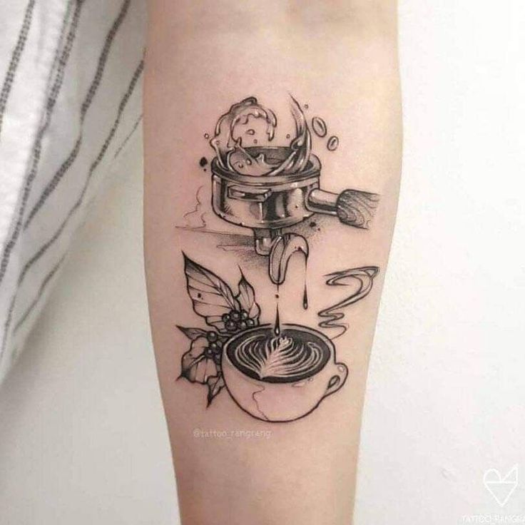 a black and white tattoo on the leg of a person with a cup of coffee