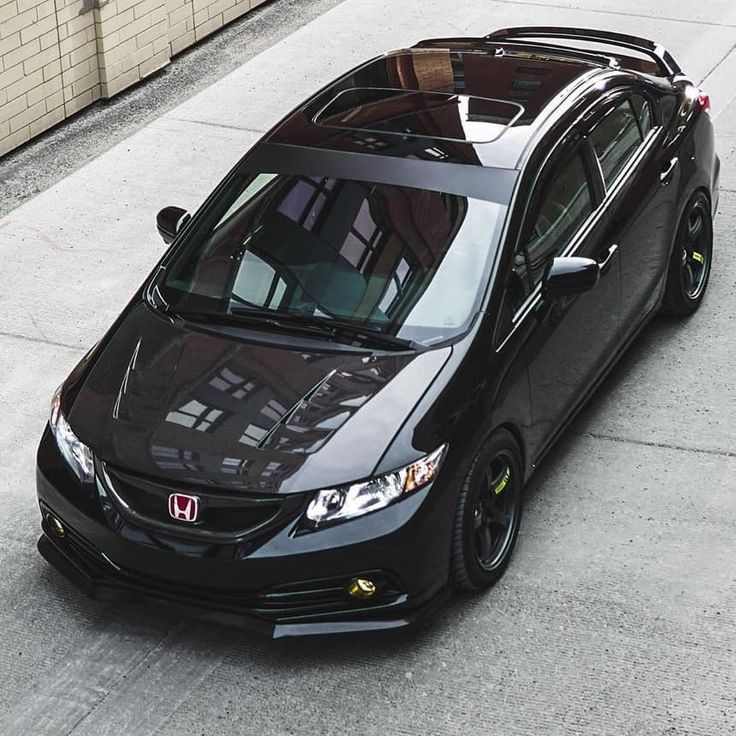 a black car parked on the side of a road