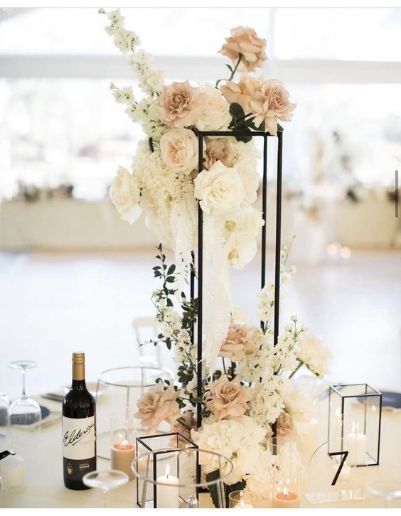 an elegant centerpiece with flowers and candles