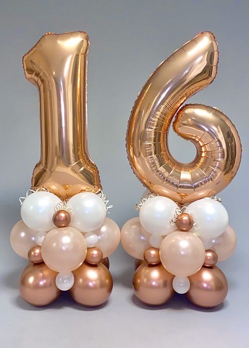 the number six is made out of gold and white balloons, which are attached to each other