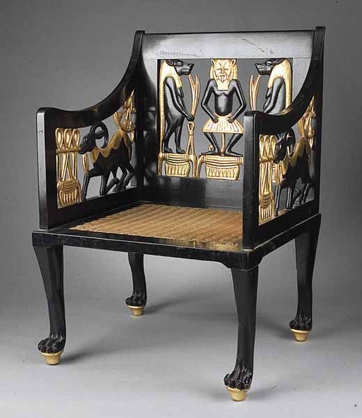 an old wooden bench with gold and black designs on it's backrests