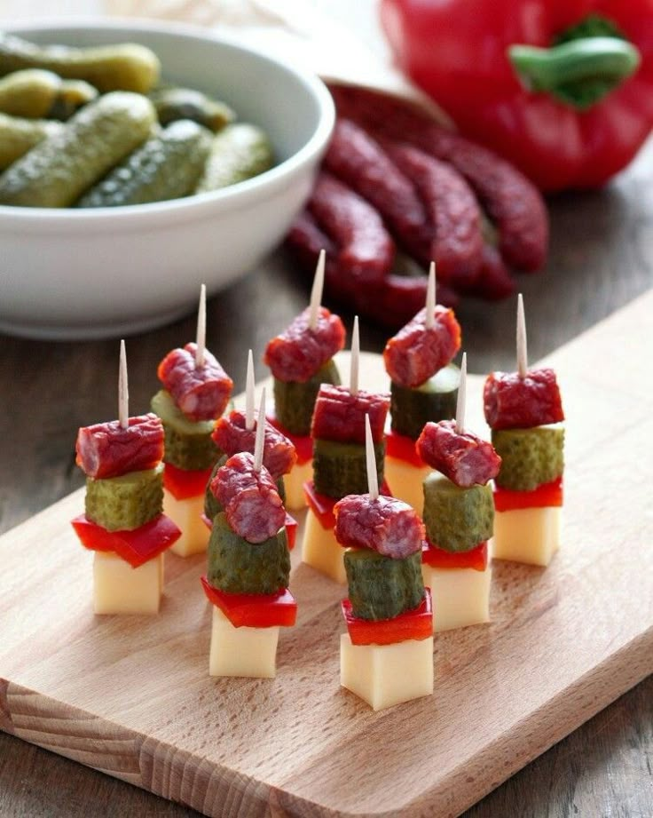 small appetizers with pickles and cheese on a cutting board