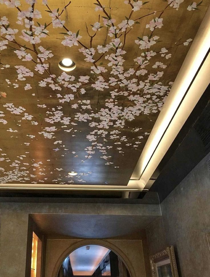 the ceiling is decorated with pink flowers and gold leaf designs, along with an arched doorway