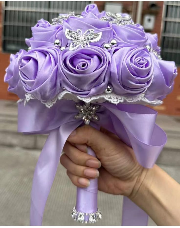 a person holding a bouquet of purple roses