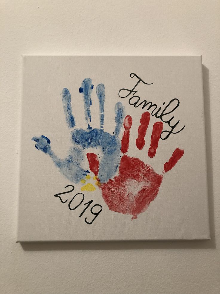 a family hand print is displayed on the wall above a sign that reads, family 2013