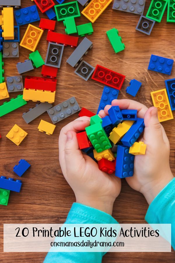 a child is playing with legos on the table and there are lots of them