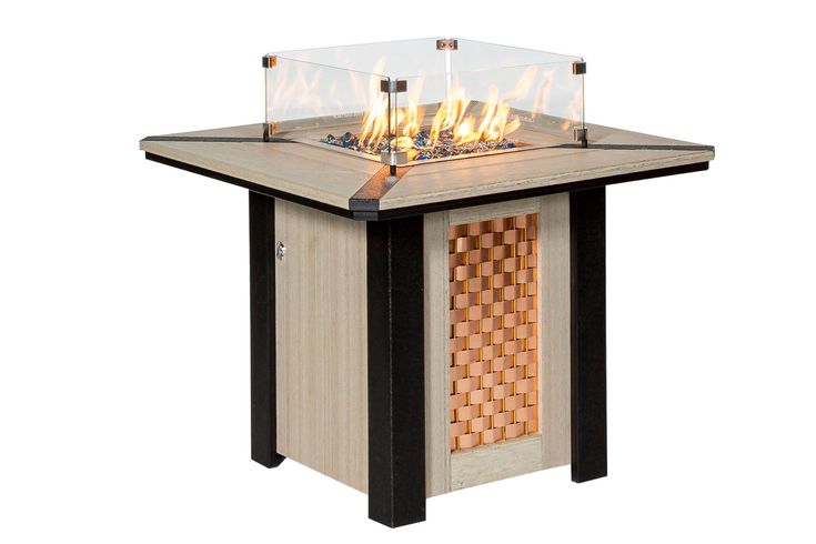 an outdoor fire pit sitting on top of a wooden table with flames coming out of it