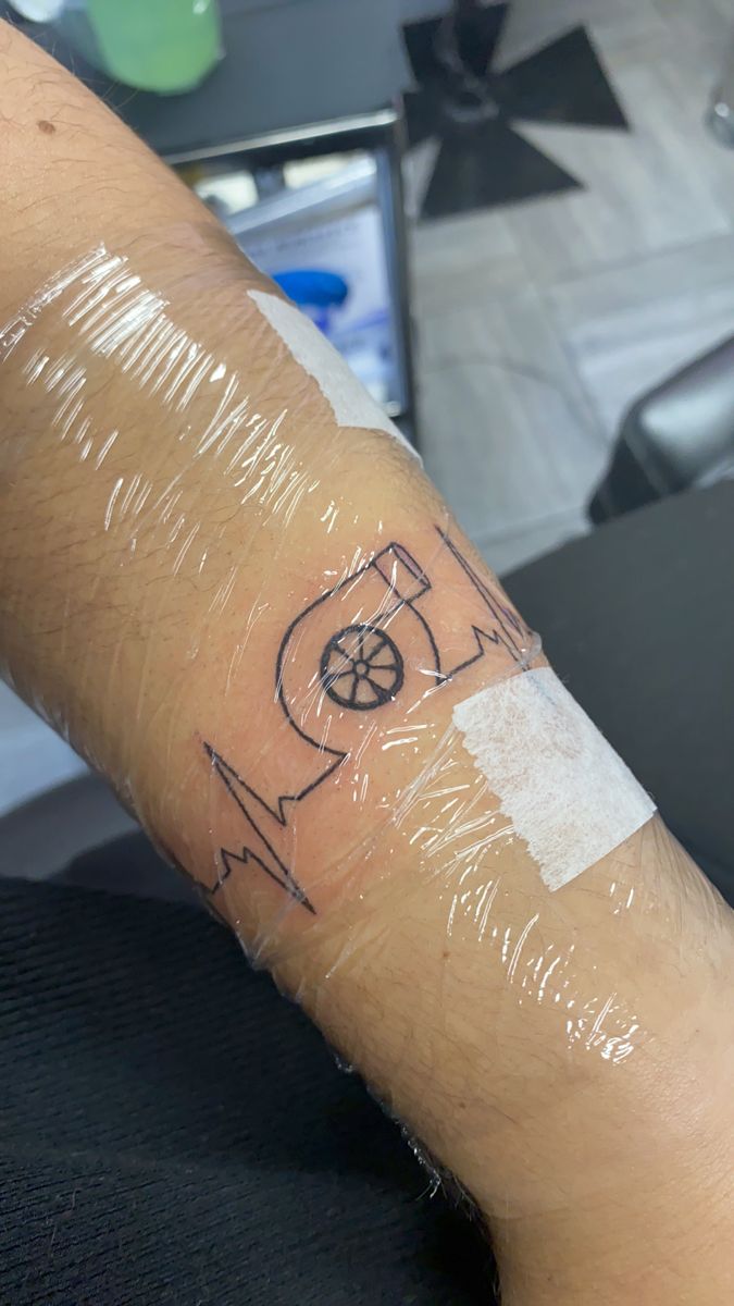 a person's arm with a tattoo on it that has an arrow in the middle