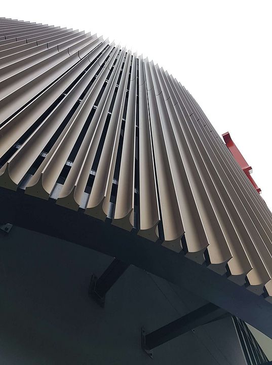 the top of a building with many vertical lines on it