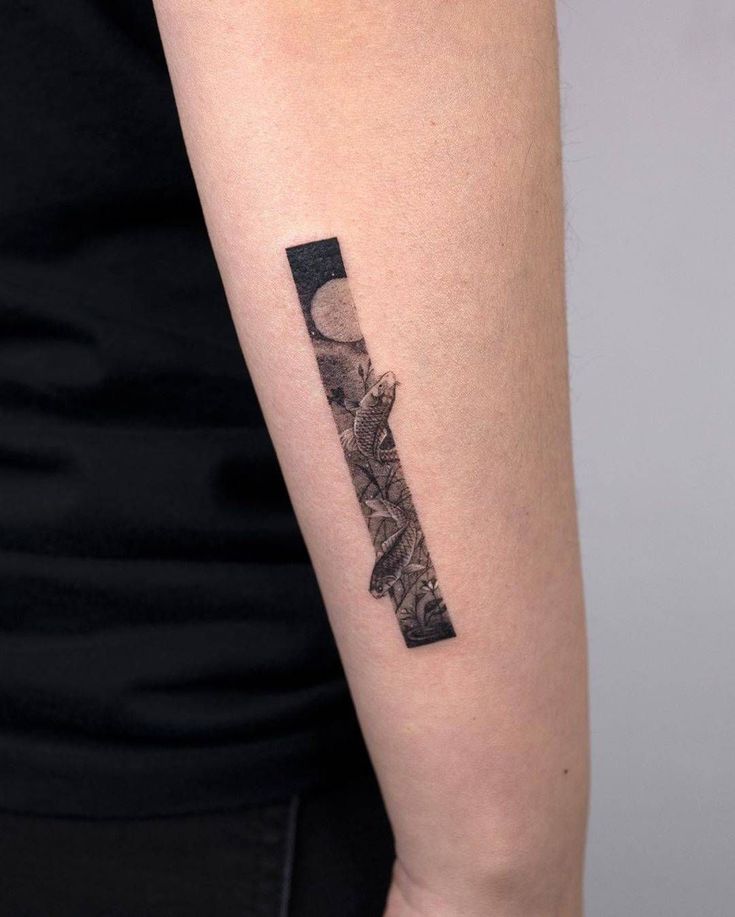 a woman's arm with a black and white tattoo design on the left forearm