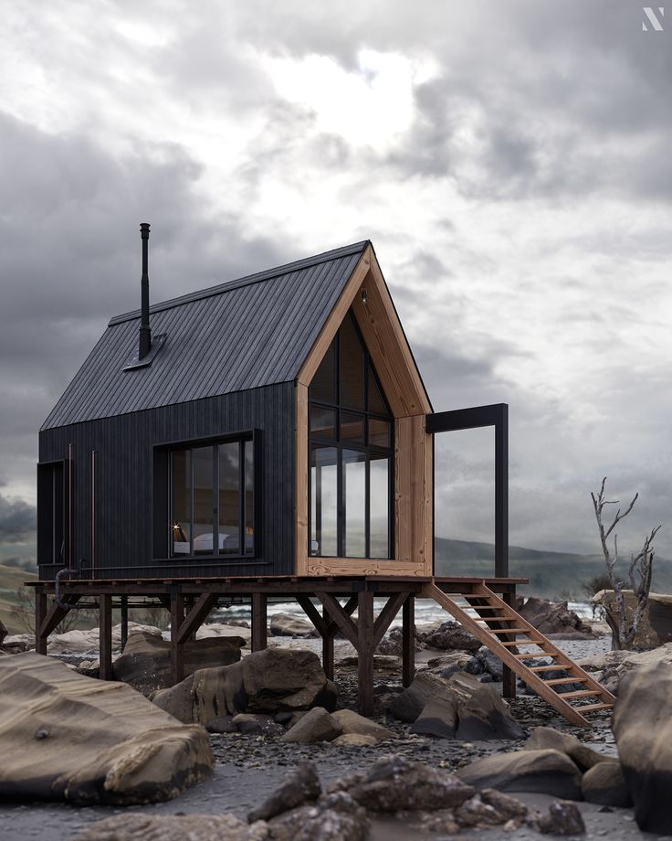 a small house sitting on top of a rocky beach