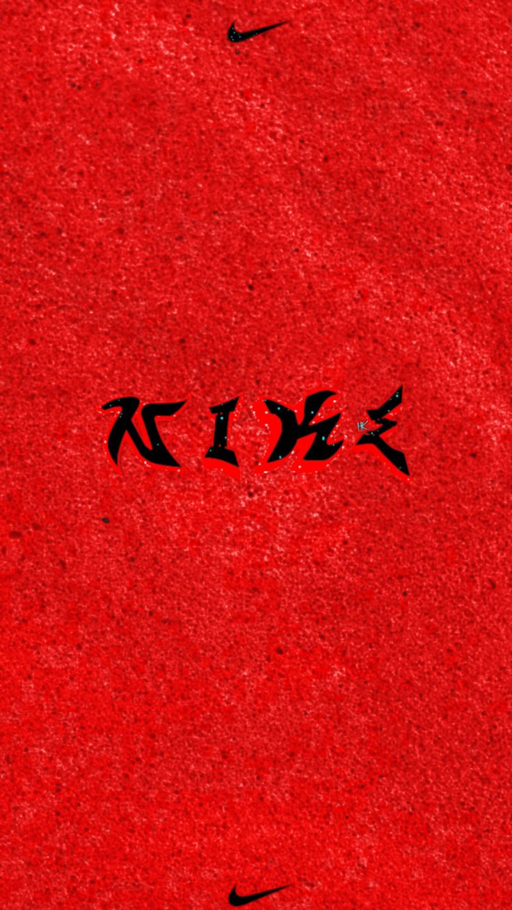 the word nike written in black ink on a red surface with two birds flying overhead