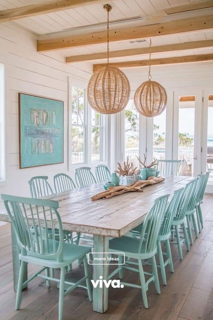 the dining room table is made from wood and has blue chairs with matching turquoise accents