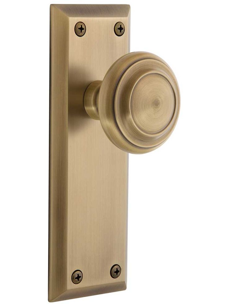 an antique brass door handle with a round knob on the front and side of it