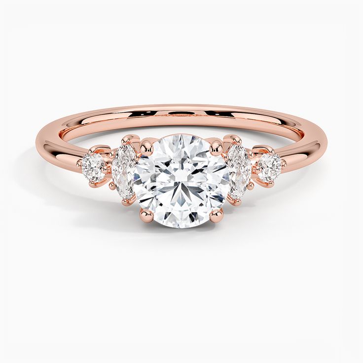 a rose gold engagement ring with three stones