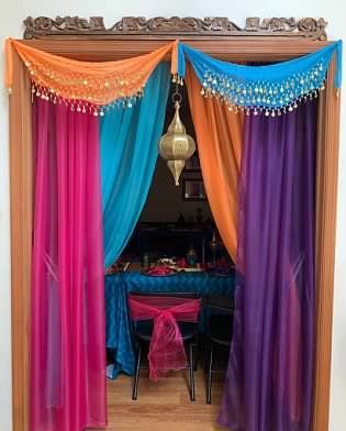 an open door to a room with colorful curtains