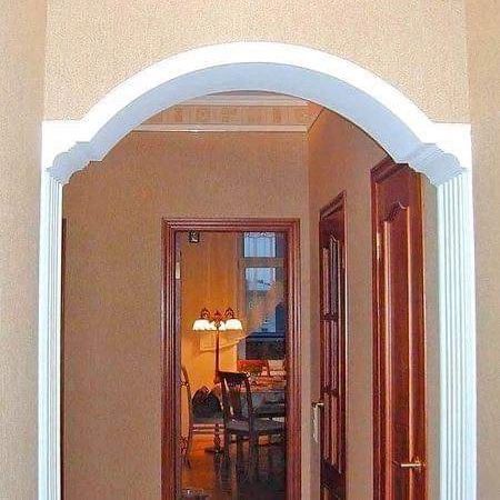 an archway leading into a living room and dining room