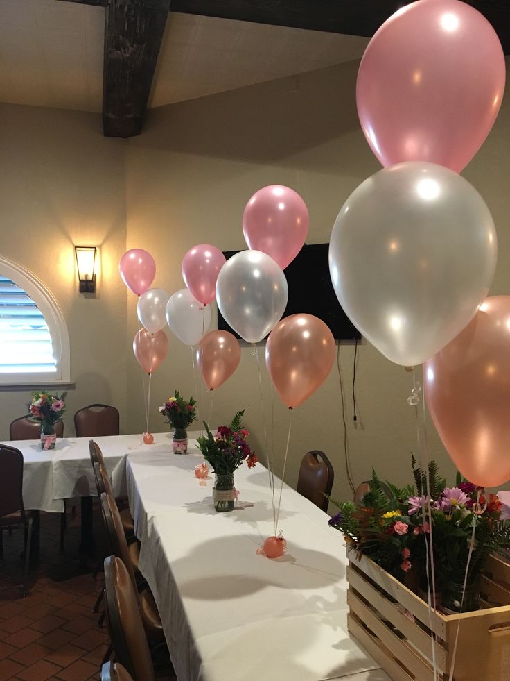 there are many balloons on the table at this wedding reception and it looks like they were floating in the air