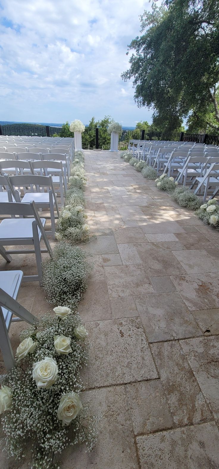 rows of chairs with white flowers on them