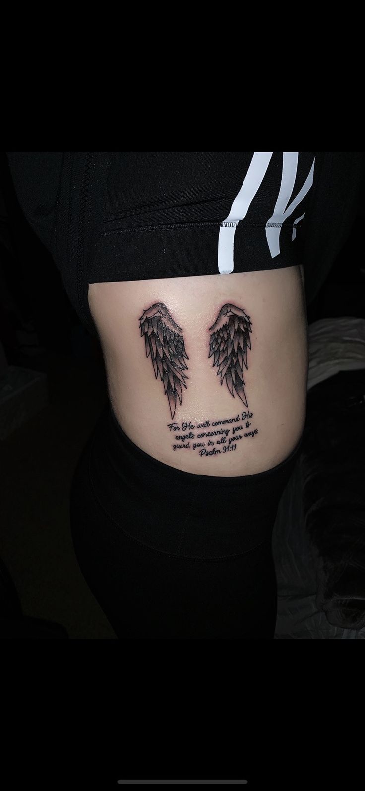 a woman's stomach with two black wings on it and the words, i love you