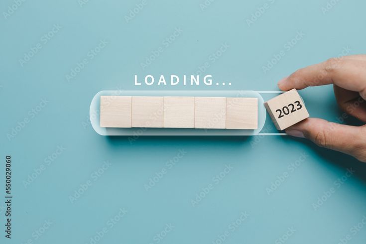 a hand holding a block of wood with the word loading on it and another block that says loading