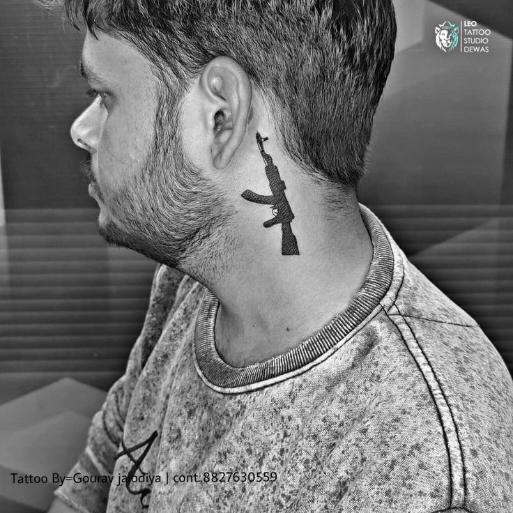 a man with a tattoo on his neck