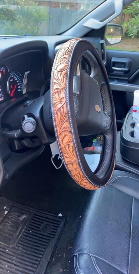 the interior of a car with a steering wheel cover