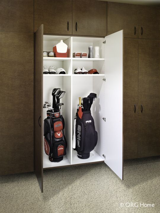 two golf bags are sitting in a cabinet