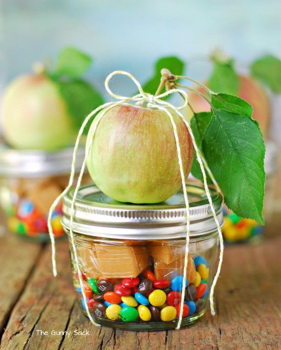 an apple in a jar filled with candy