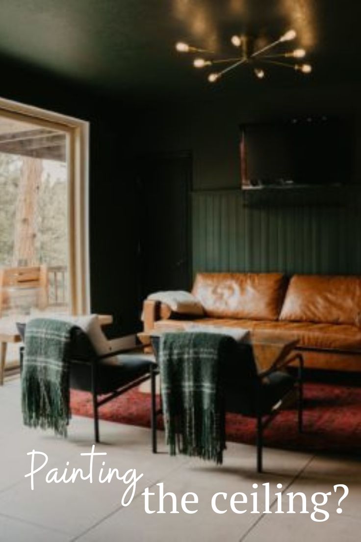 a living room filled with furniture and a painting on the wall above it that says painting the ceiling?