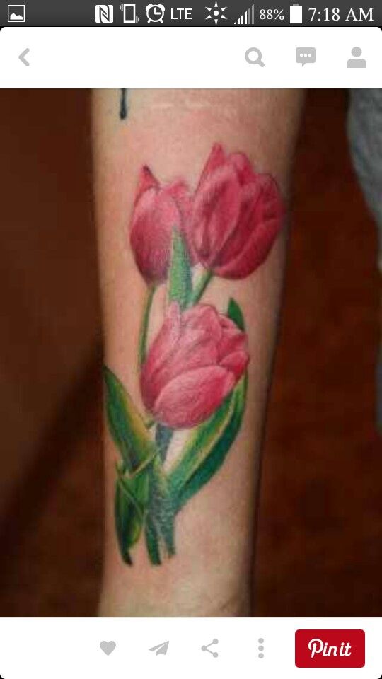 a woman's arm with pink flowers on it