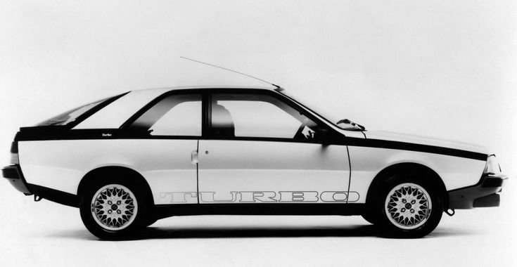 an old photo of a white car with the word turboexc on it's side