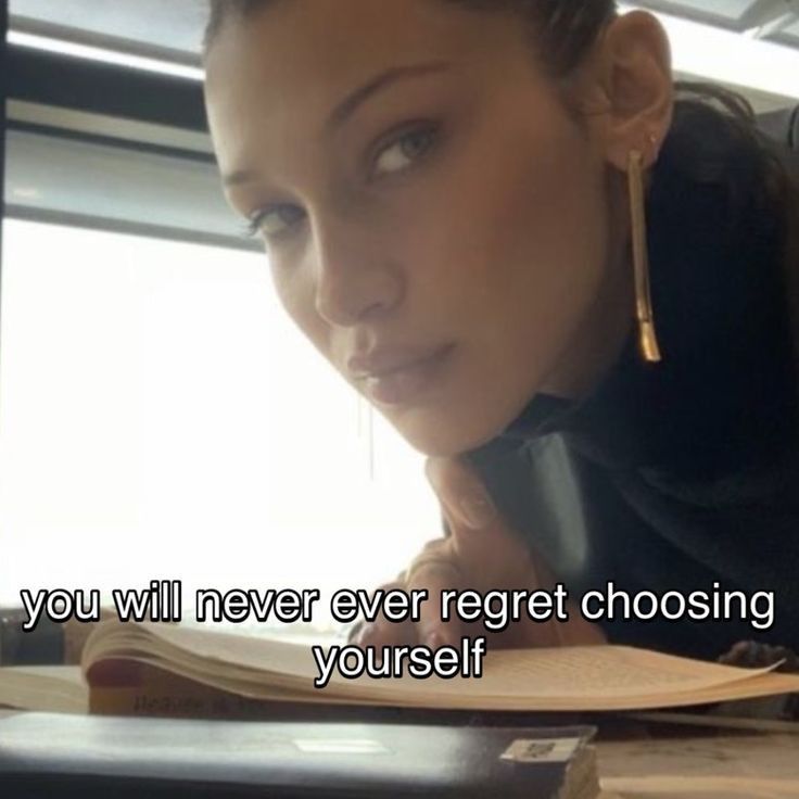 a woman sitting at a desk with an open book