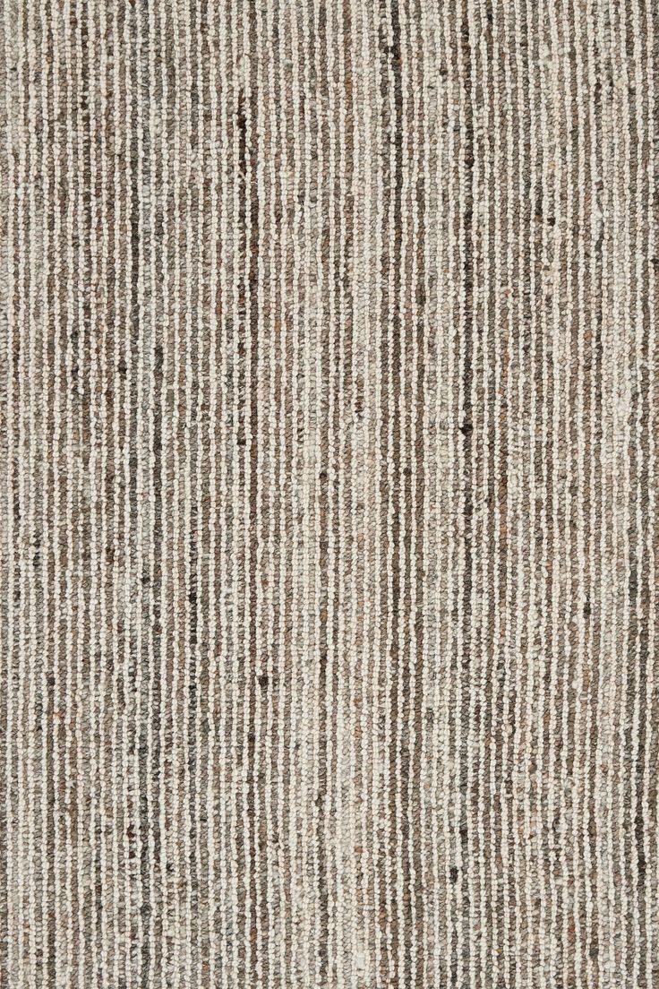 an area rug with vertical stripes in brown and white colors on top of each other