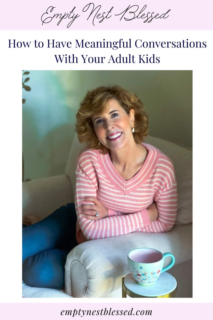 a woman sitting on a couch with her arms crossed and coffee mug in front of her