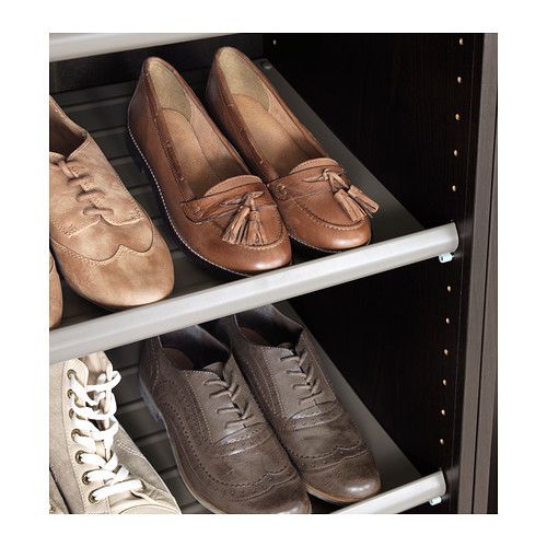 several pairs of shoes are lined up on the shelves in a shoe rack, one is brown and one is tan