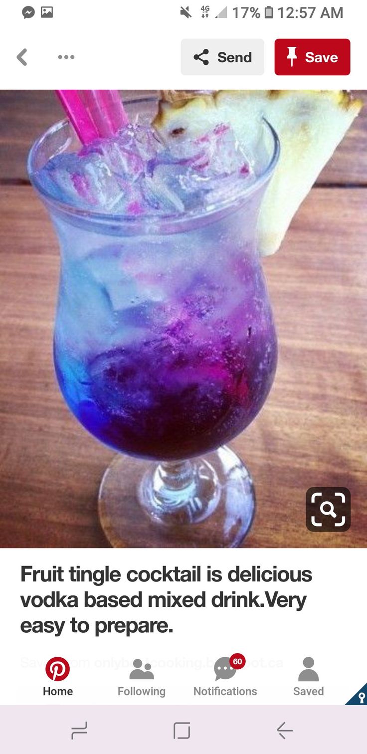 a purple drink in a glass on top of a wooden table