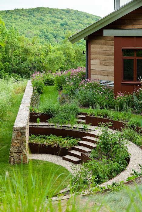 an outdoor garden with steps leading up to the house