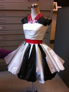 a dress that is sitting on a mannequin in front of a filing cabinet