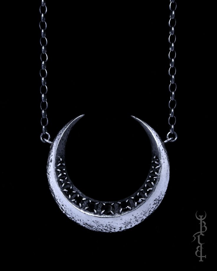 In honour of Artemis, Goddess of the wilds and Goddess of the moon. She who wears the crescent moon crown. This necklace features a faceted crescent moon lined with a row of 13 gemstones. Each of the gemstones are meticulously set by hand, with each claw that secures the gemstones being painstakingly, individually handcrafted. The surface of the crescent moon is uniquely textured with lunar craters and crosshatched markings that give it the appearance of an ancient relic. The necklace is produced entirely in sterling silver which is treated with a dark patina then brightly polished to highlight the depth of all the intricate details.  -GEMSTONES- The Artemis necklace comes in three gemstone options: Black Spinel- Deliciously dark and glossy, completely opaque and void of colour Moonstone- Artemis Necklace, Moon Crown, Artemis Goddess, Goddess Of The Moon, The Wilds, Bone Jewelry, Dark Style, True North, Dark Gothic