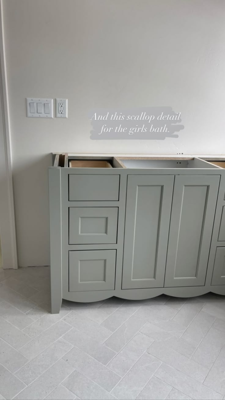 a bathroom vanity with two sinks and cabinets in the same color as it appears to be painted