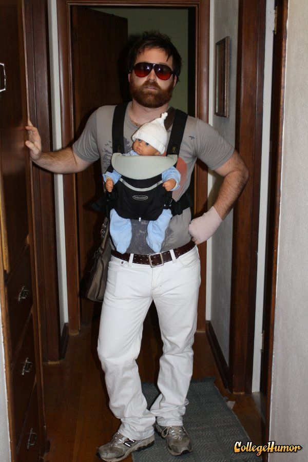 a man holding a baby in his sling