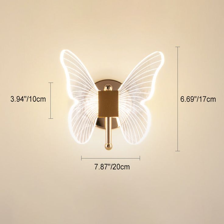 a wall mounted light with a butterfly design on the side and measurements for it's size