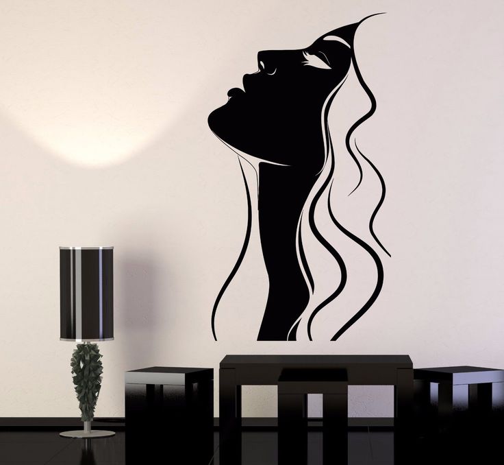 a woman's face with long hair wall sticker on the wall next to a table