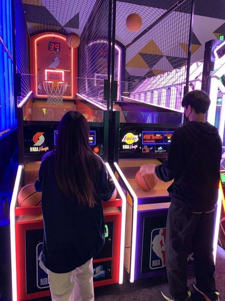 two people playing basketball in an arcade