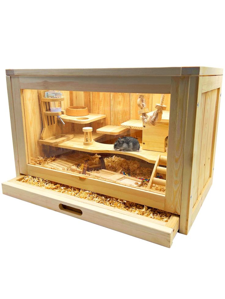 a wooden box with two hamsters in it's cage and one laying on the floor